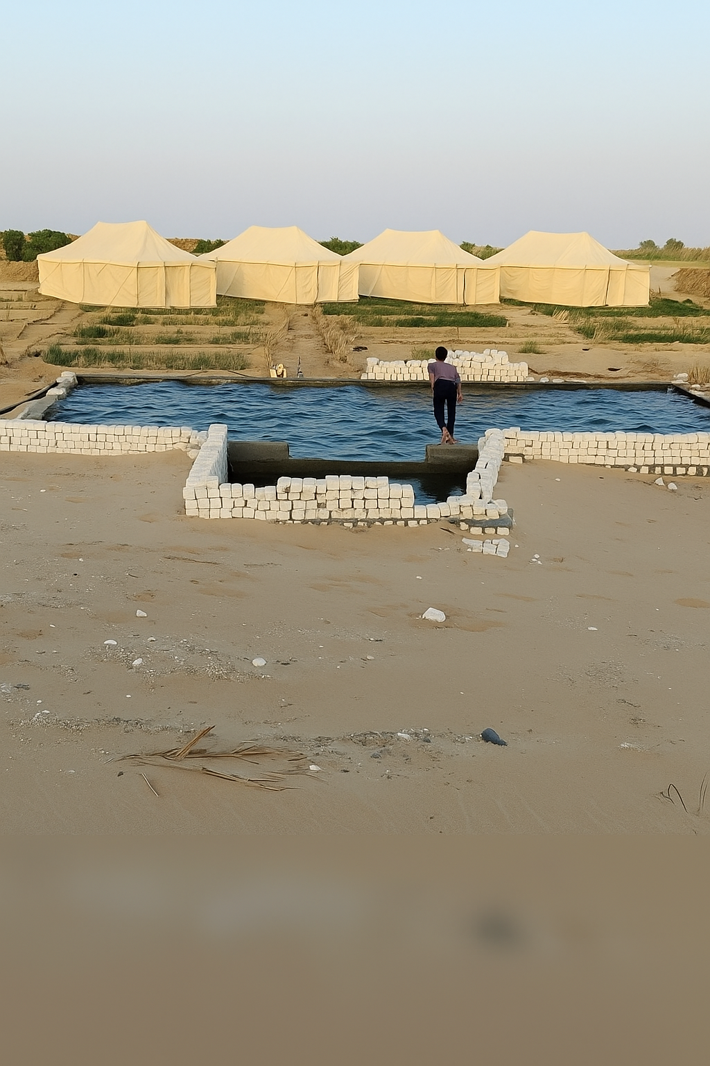 Natural pool and traditional desert tents at Amon Whisper Dunes Siwa